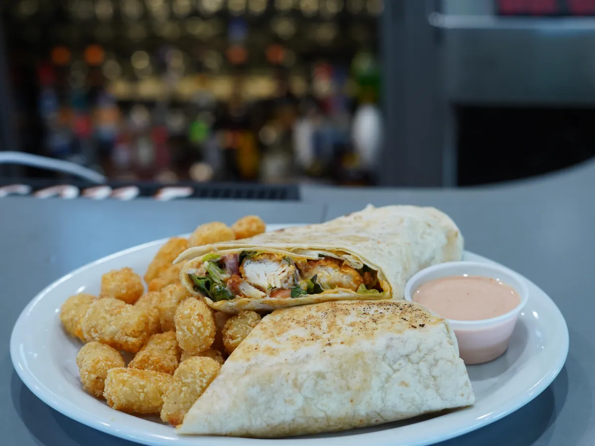 Wrap and tater tots with dipping sauce