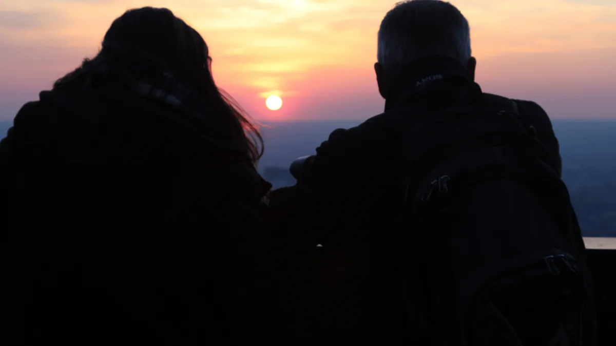 happy couple looking at the sunset