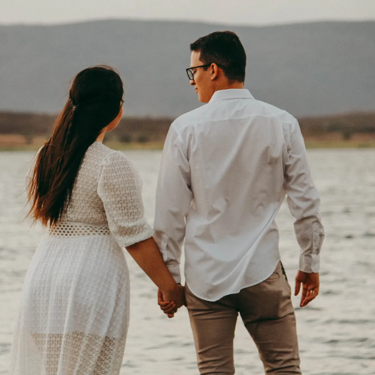 happy couple walking on beach