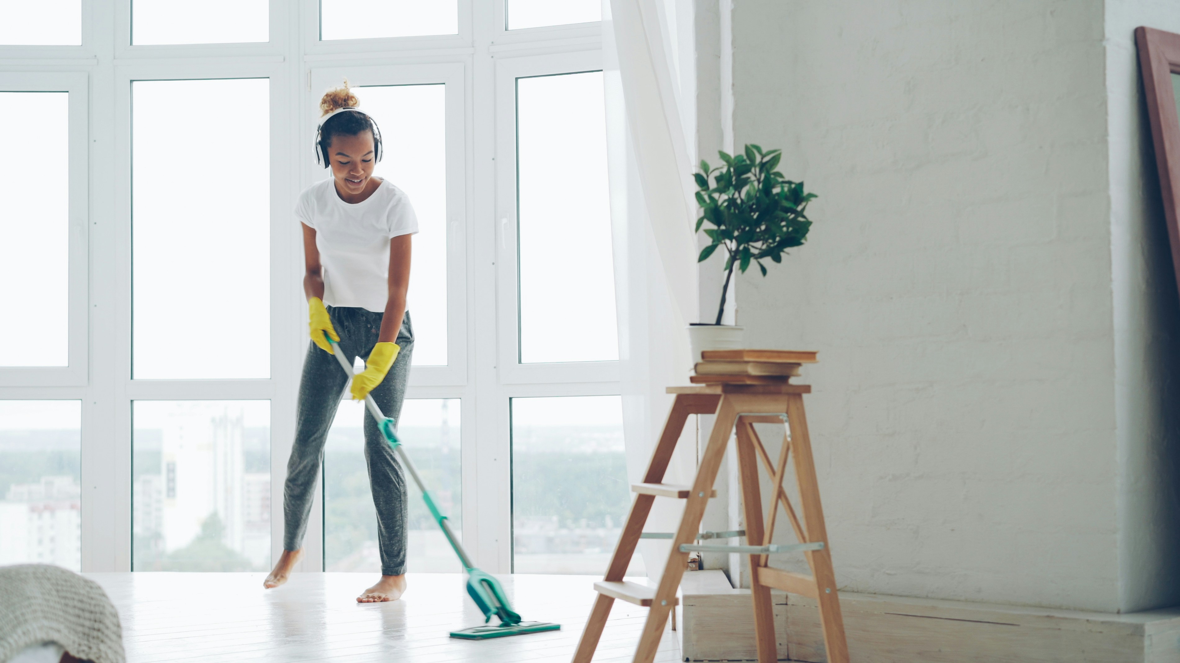 Woman mopping floors in a bright clean home - Residential Cleaning - Supreme Sparkle Solutions