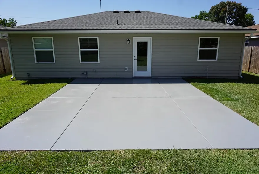 Freshly finished concrete patio attached to the back of a home in Lake City, Florida