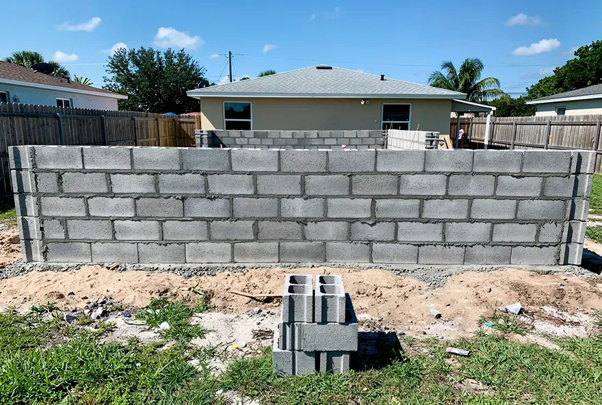 Concrete block wall under construction on a residential property in Lake City, Florida