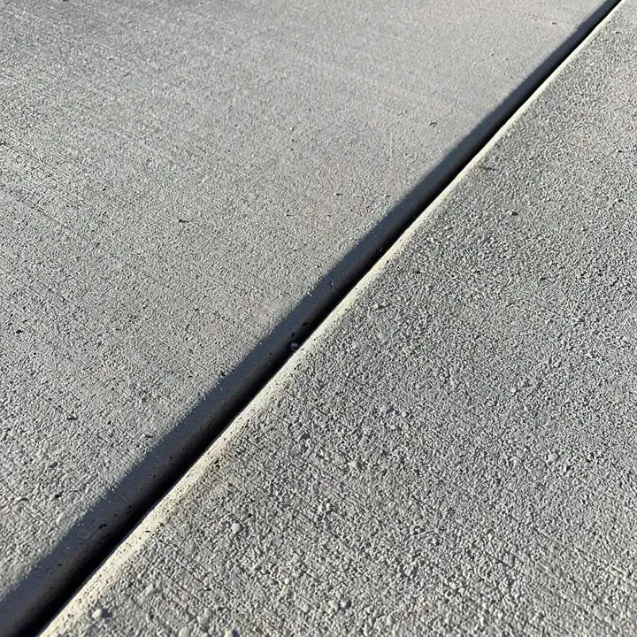 Close-up of a settled concrete surface with expansion joint in Lake City, Florida