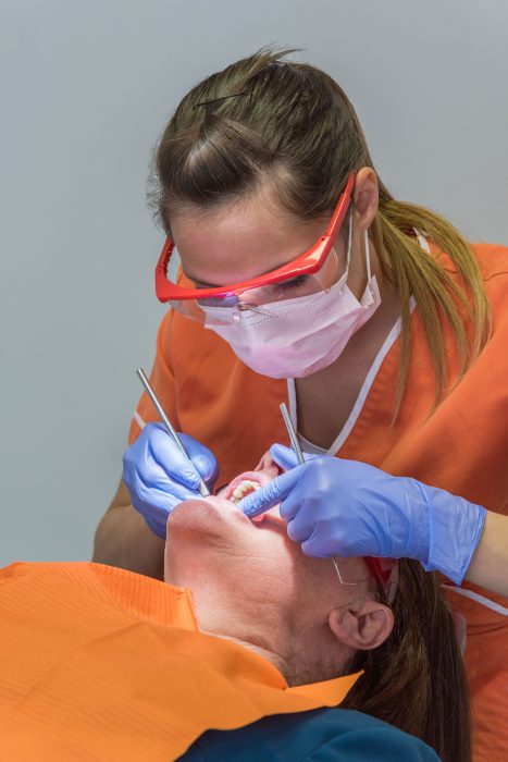 Dentists working on a patient's teeth