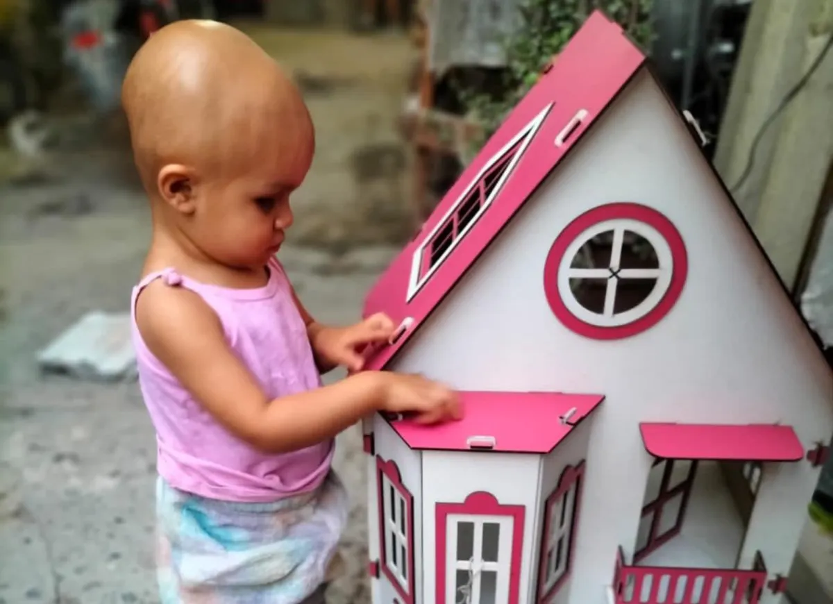 three men laughing while looking in the laptop inside room