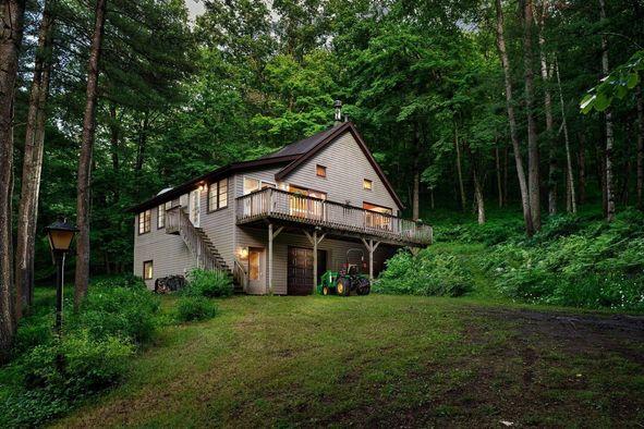 a room with a wood floor and large windows