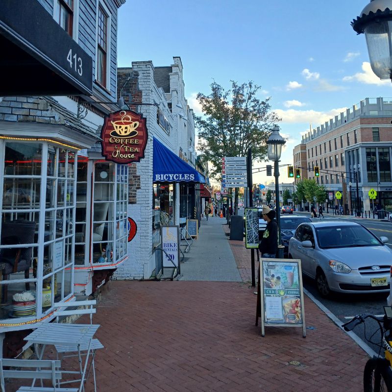 View down a downtown Montclair, NJ street from a coffee shop window, with pedestrians and storefronts visible