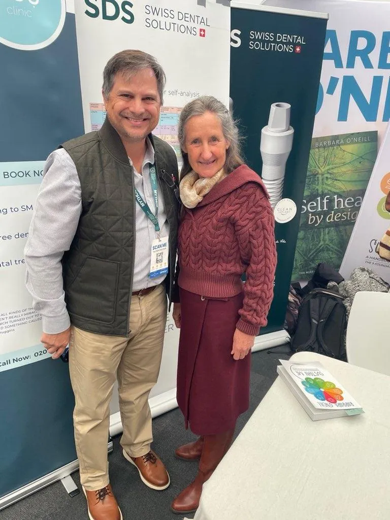 Matt Piell at a wellness conference, standing beside leaders pioneering innovative health systems