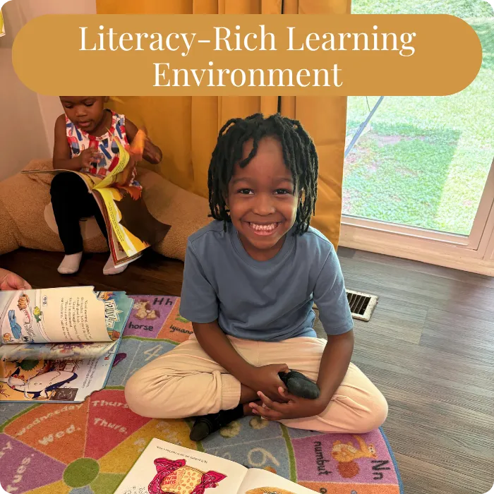A smiling Black child sits cross-legged on a colorful alphabet rug surrounded by open books at daycare in Smyrna