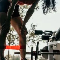 female doing a workout using resistance bands and weights