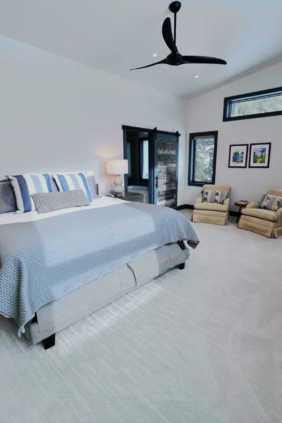 woman setting sheets on bed