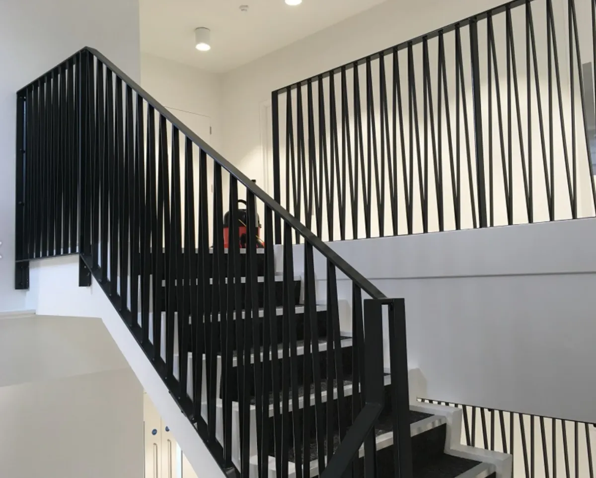 selective color photo of man on top of gray building