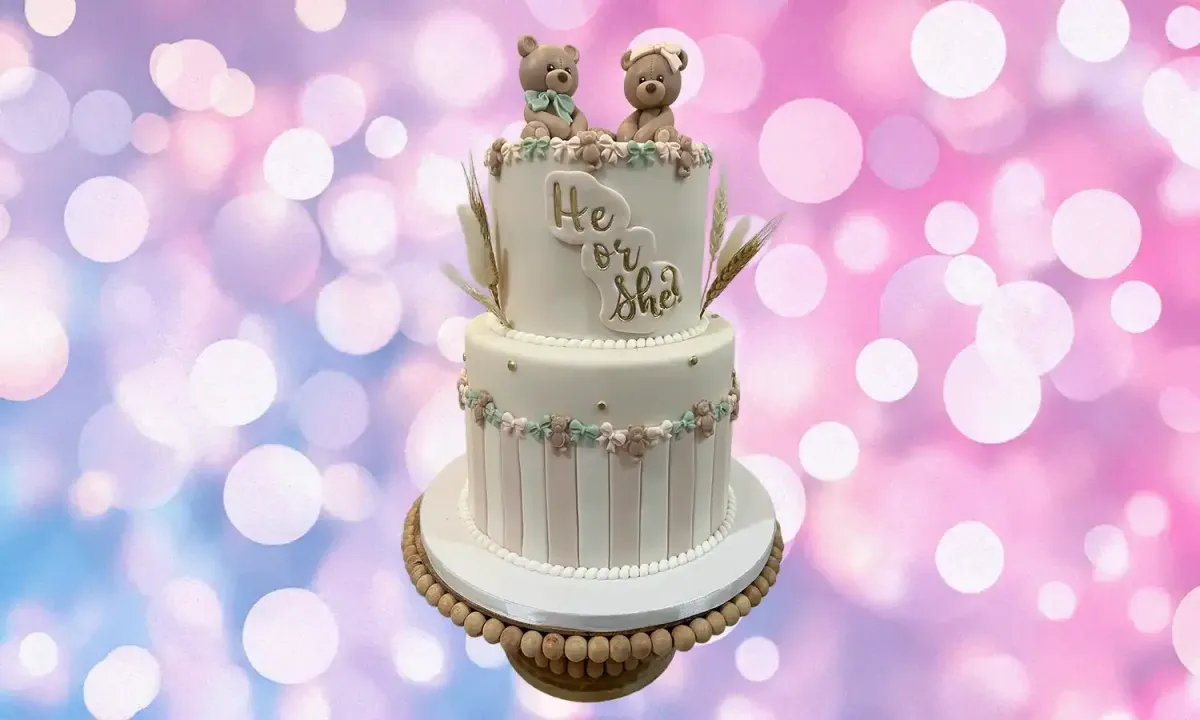 Modern gender reveal cake featuring pastel accents