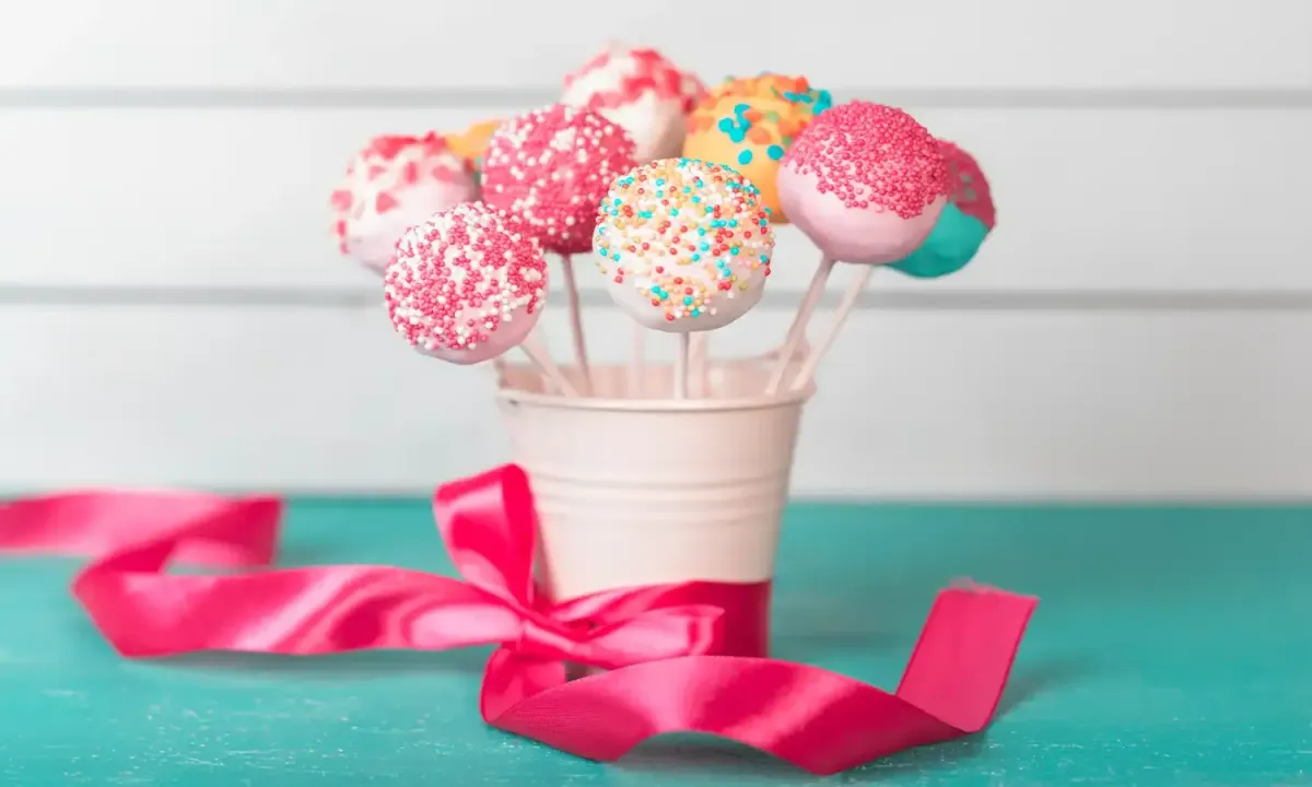 Delicious cakepop on a stick with a smooth chocolate coating and festive sprinkles