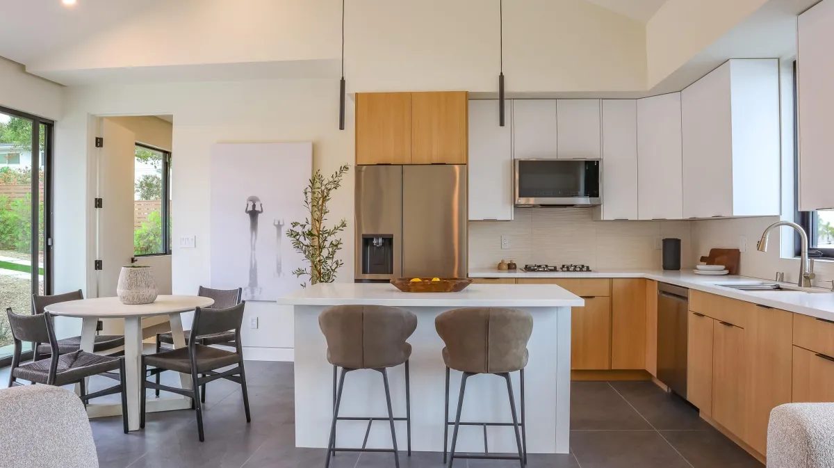 Modern kitchen remodel with natural wood cabinets and white countertops in Encinitas, California