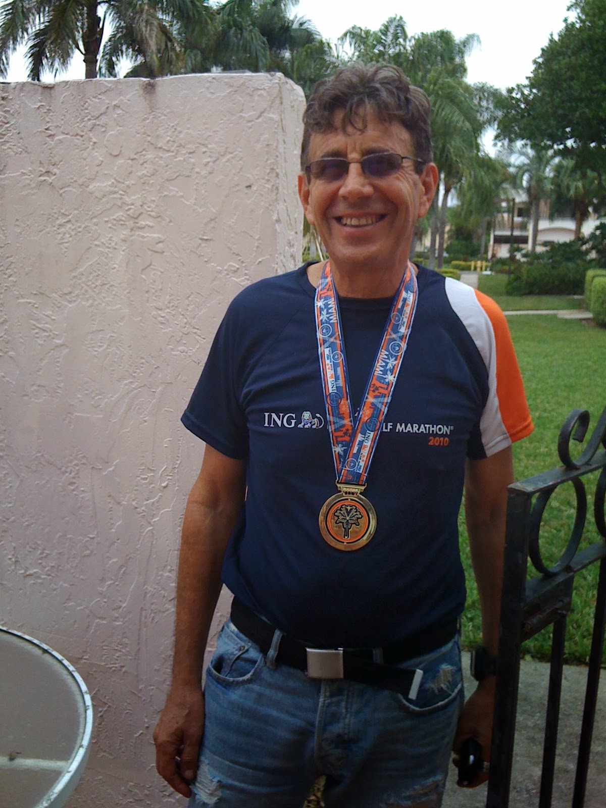 A hopeful 76-year-old man with grey hair and a gentle smile, navy sweater, soft even lighting, isolated on transparent background.