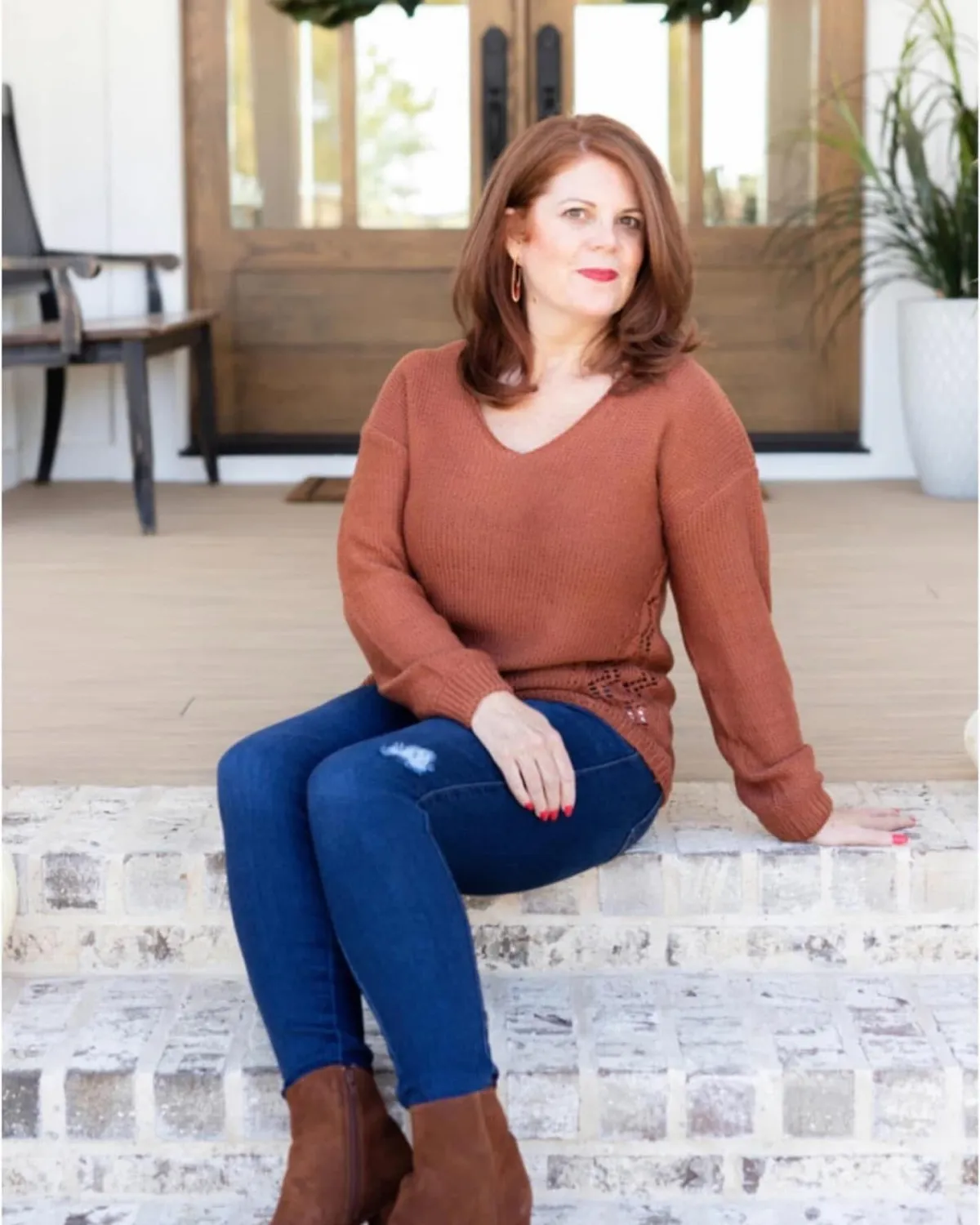 Life coach and healer Stephanie Quade leaning on a door post
