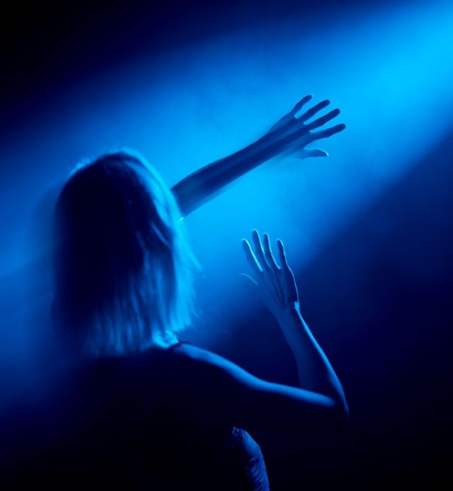 Woman with arms stretch out to the light