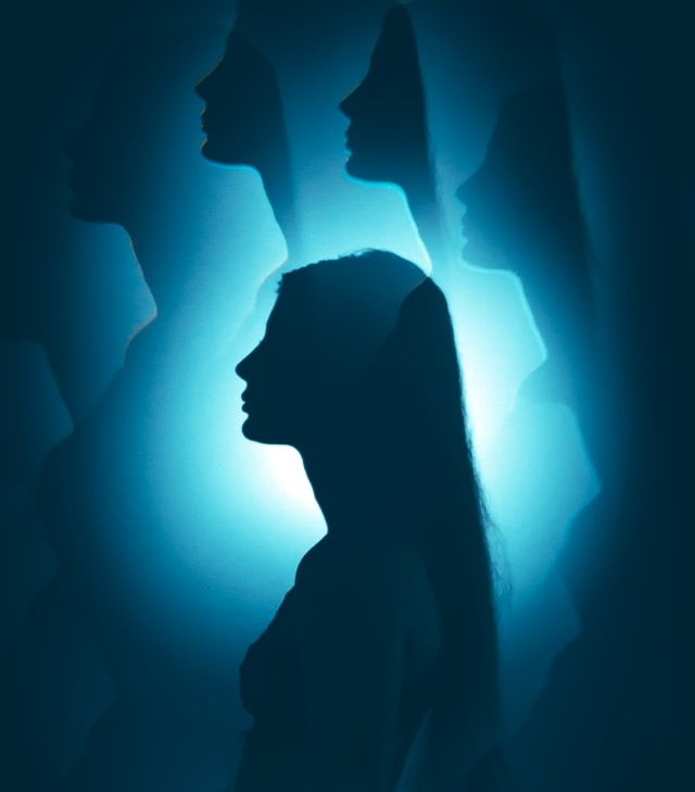 Image of a woman's head with other reflections of that head above representing multiple parts of the psyche