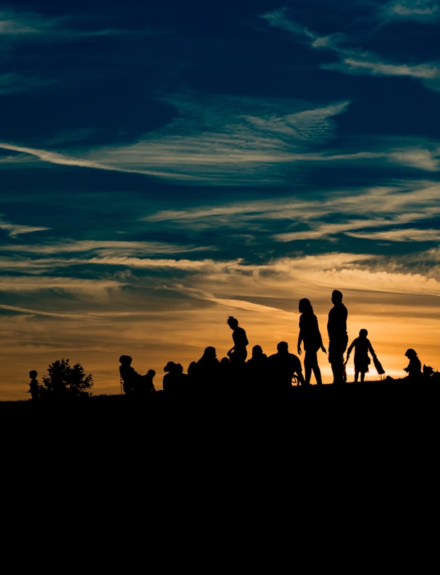 Group o people on a hill at dusk