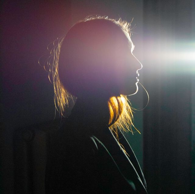 woman looking into a beam of light