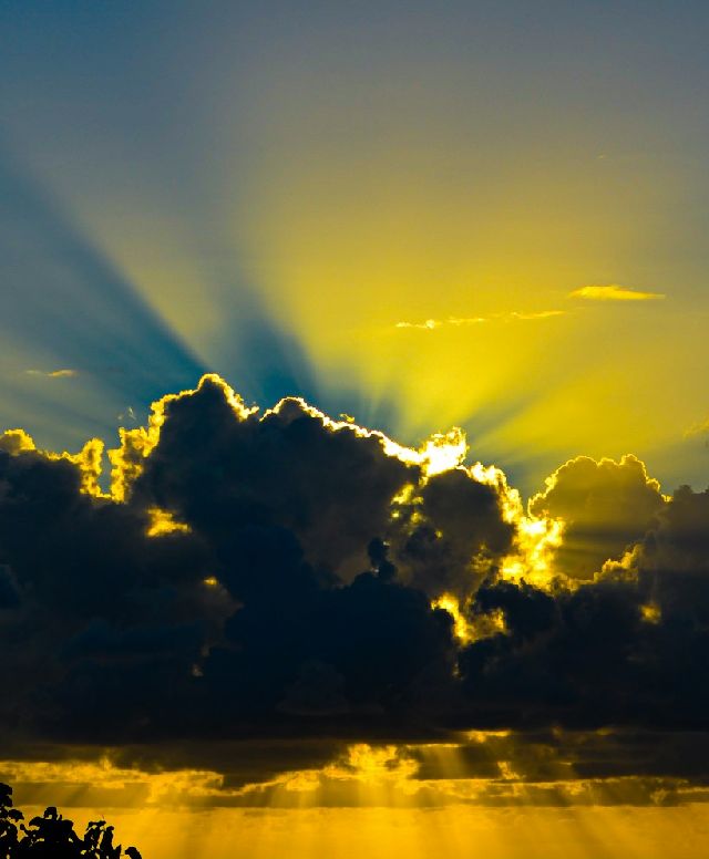 bright yellow sunlight surrounding as dark cloud