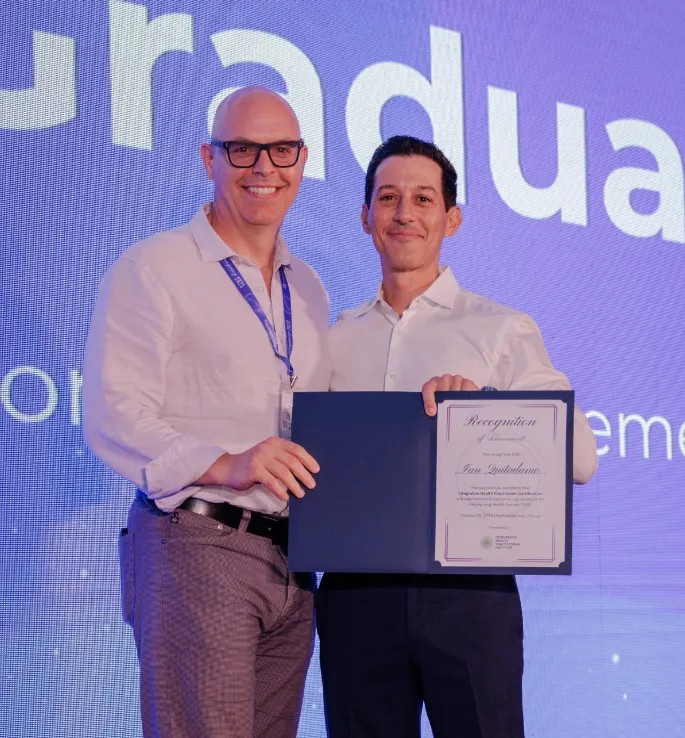 IHP Mastery Graduate, Ian Quitadamo, On Stage with Dr. Cabral