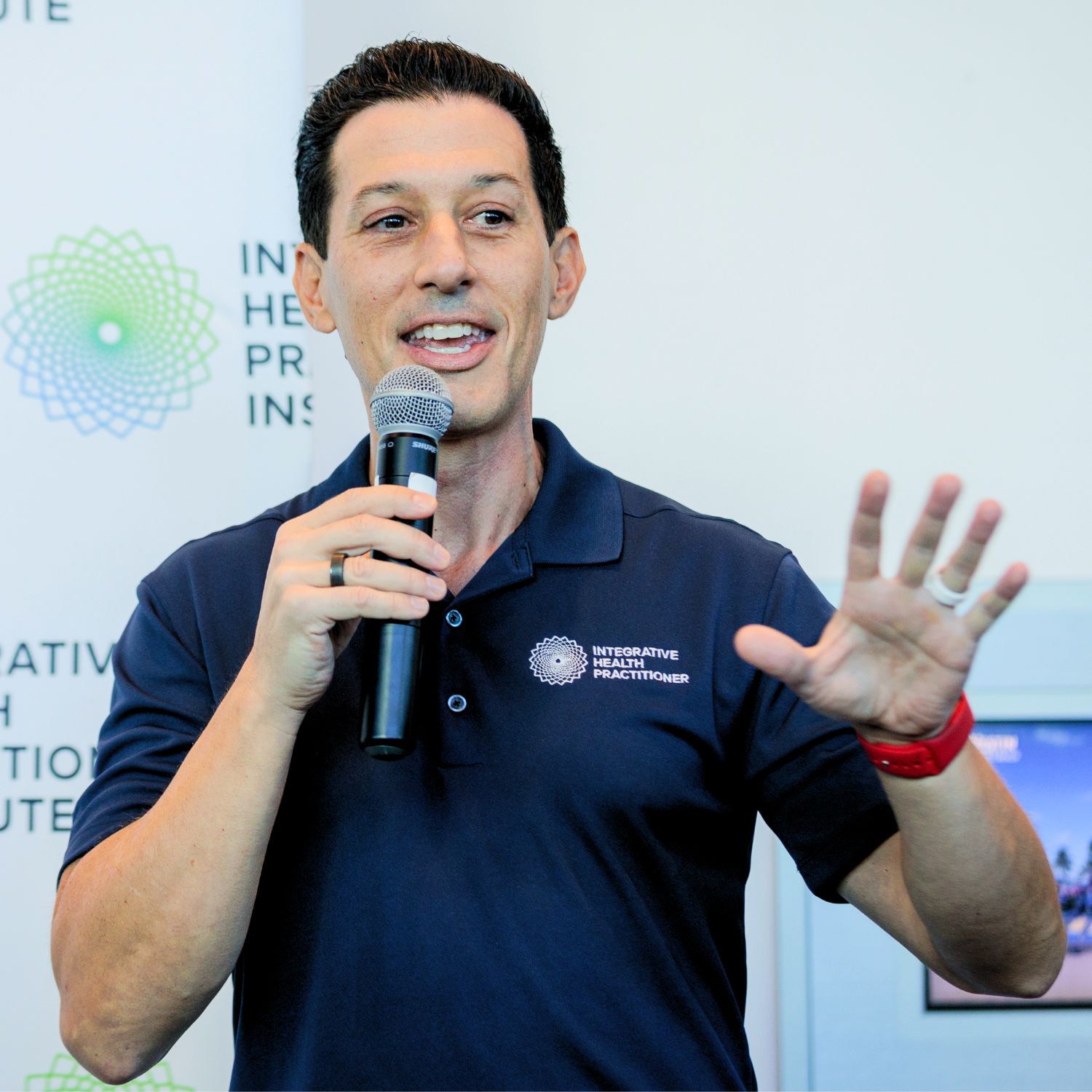 Dr. Stephen Cabral Speaking Into a Micrphone