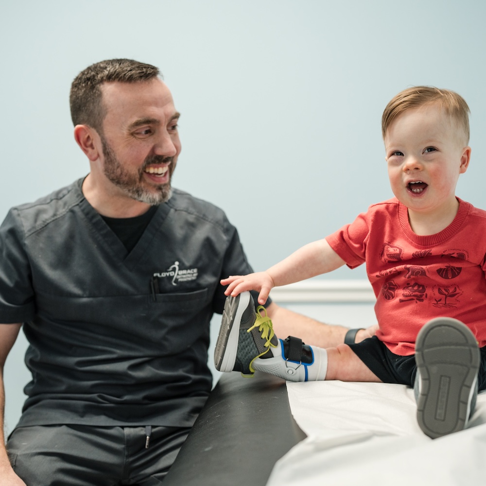elderly man with full leg prosthetic gets adjusted at floyd brace