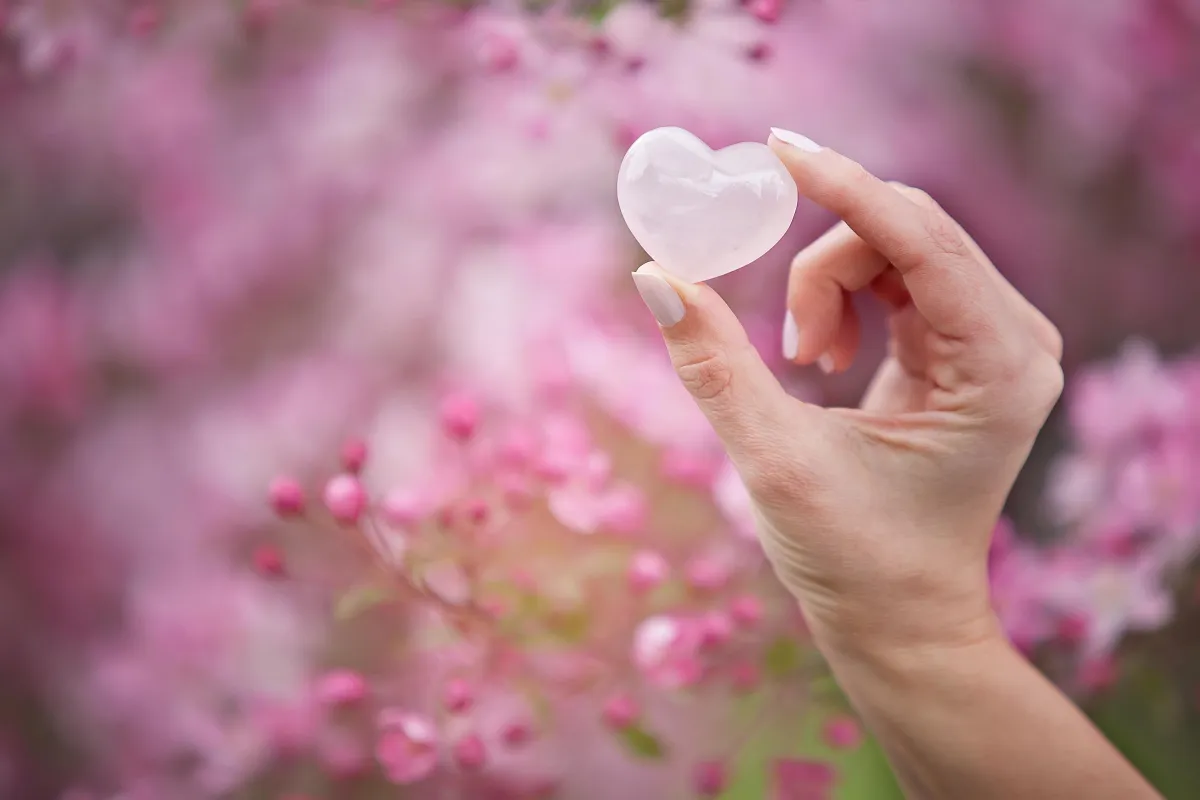 Hand Holding a Rose Quartz Heart