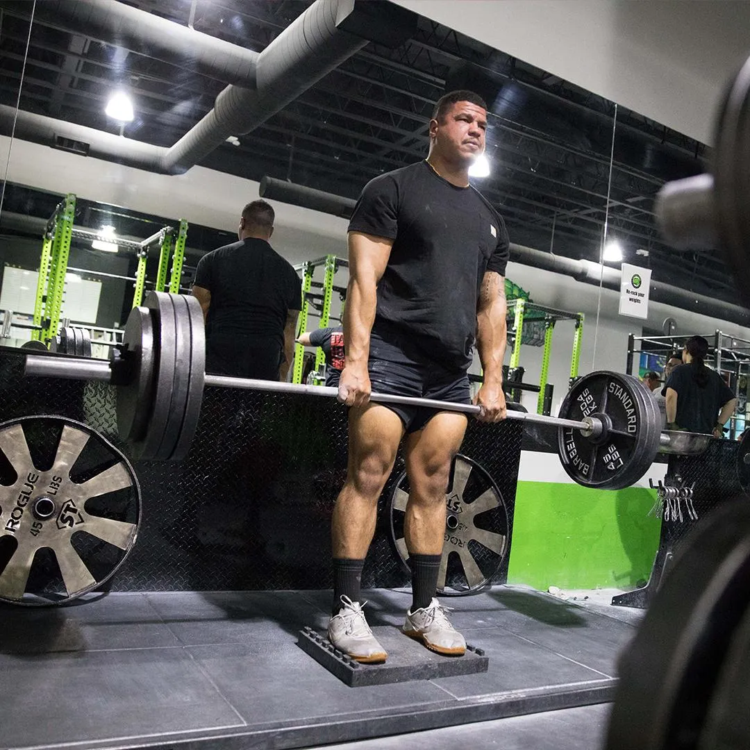 A man deadlifting 365 pounds on a deadlift platform.