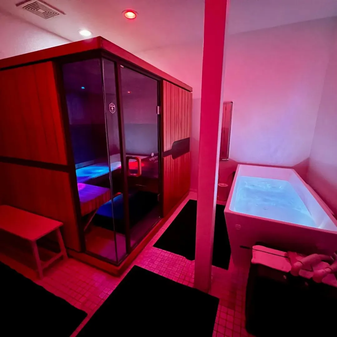 Infrared Sauna next to a cold plunge inside a private suite.