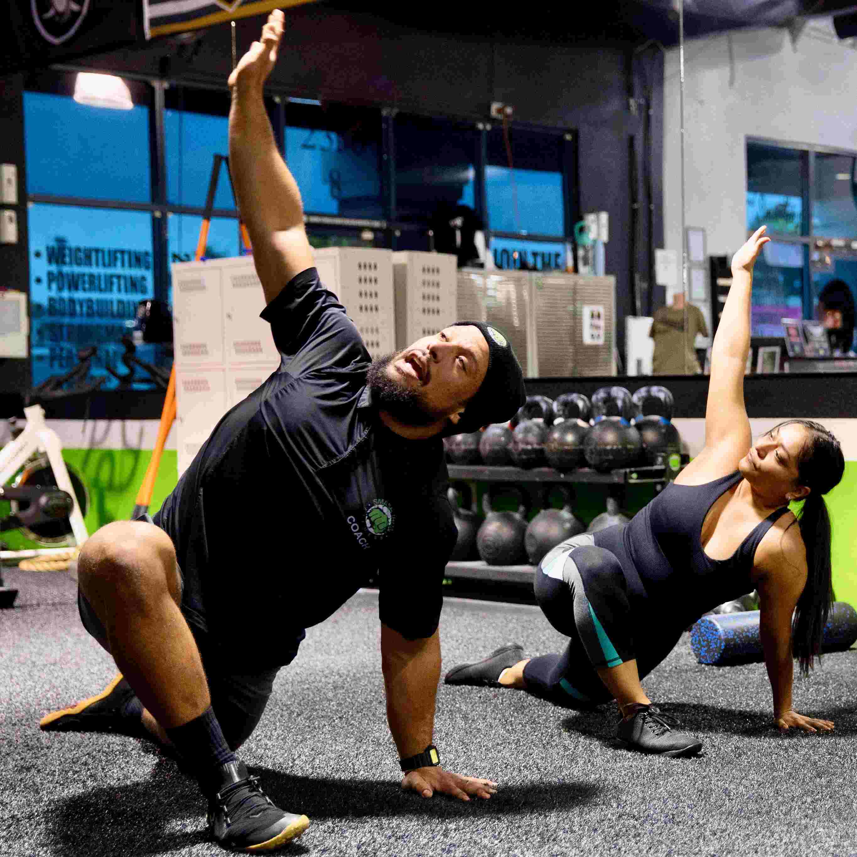 Women stretching while being coached by a trainer