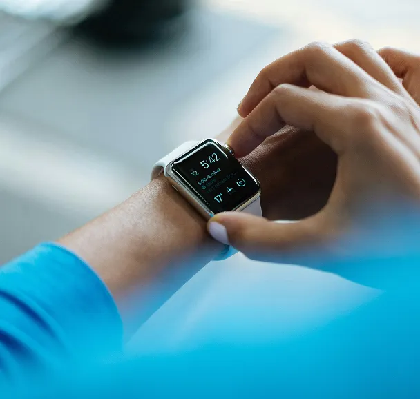 **Alt Text:** Close-up of a person wearing a smartwatch, tracking fitness and health metrics, symbolizing digital wellness, time management, and technology-assisted productivity.