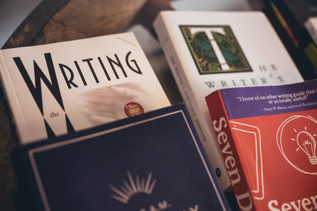 Writer how-to manuals stacked on table