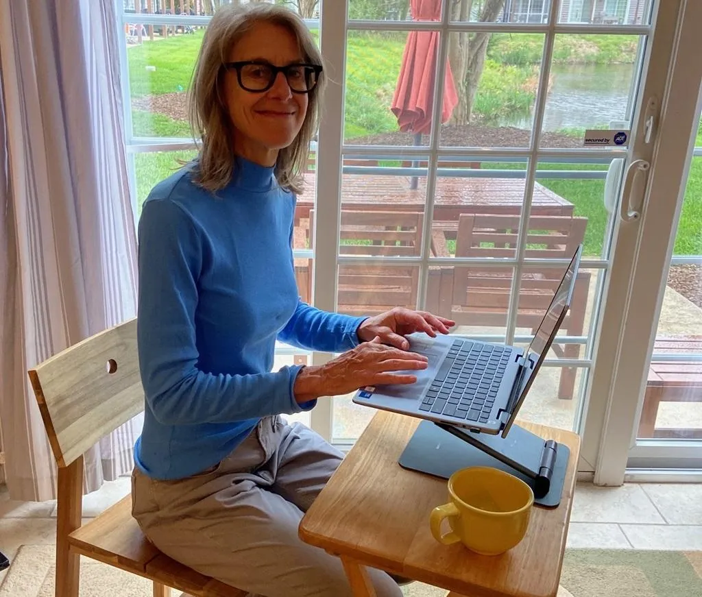 KindWrite team member Valerie Berton works on a fiction project on a laptop at her desk
