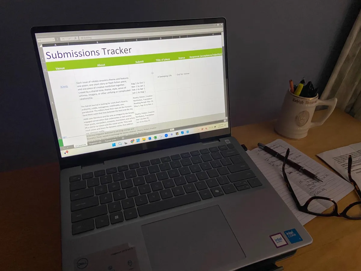 KindWrite submissions tracker displayed on laptop on KindWrite team member's desk