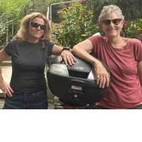 KindWrite Studio Co-Founder Diana Friedman, left, and her friend, lean against a motorcycle