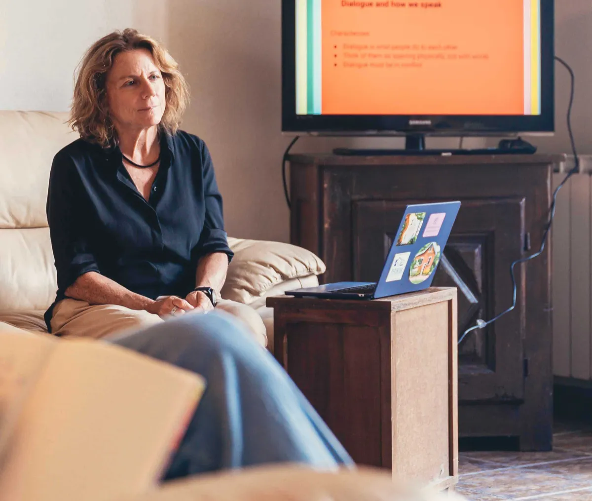 KindWrite co-founder Diana Friedman sitting by laptop leading a retreat