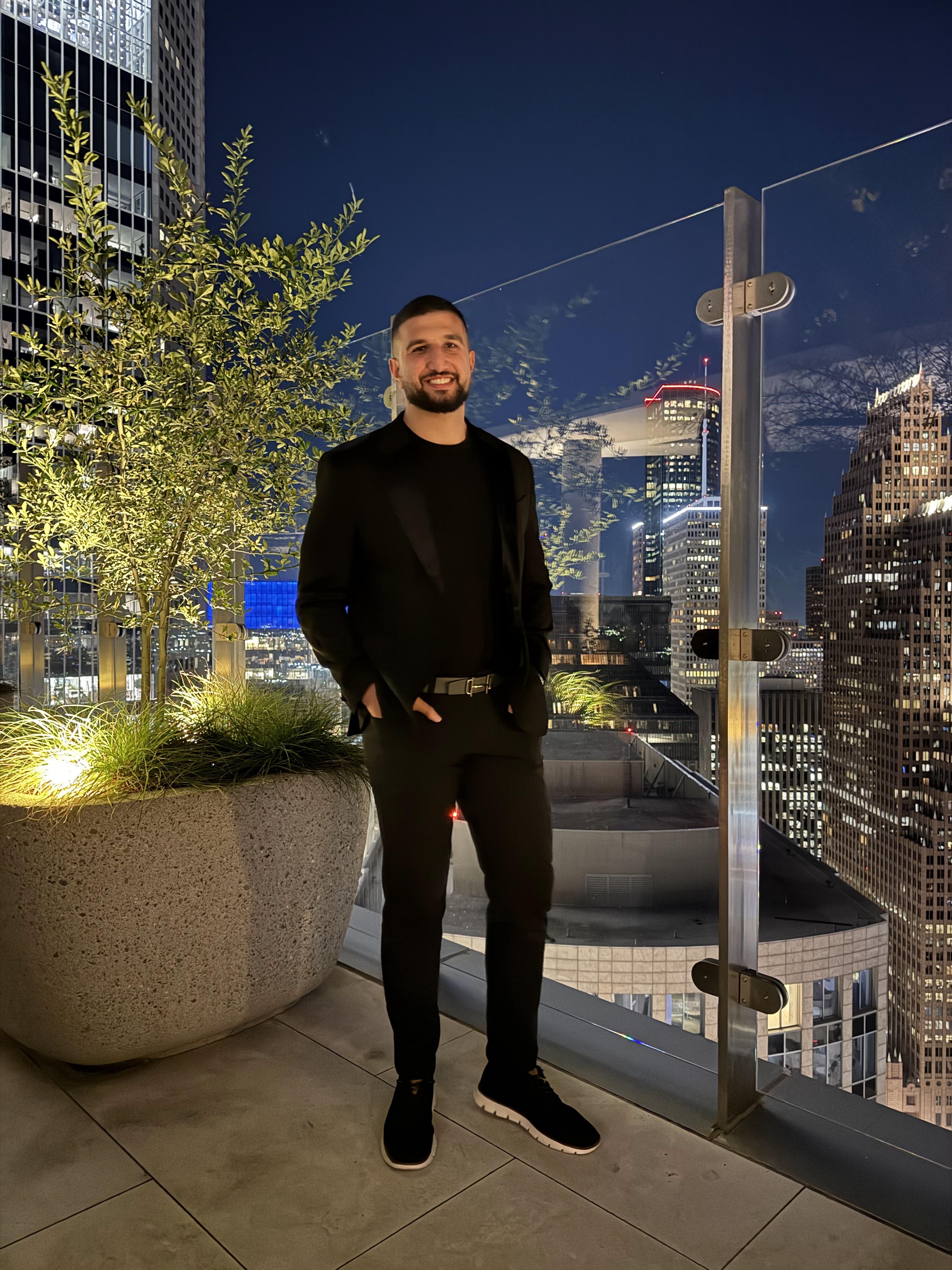 Aziz, Senior Luxury Real Estate and Mortgage Advisor, dressed in bespoke tailoring in an elegant architectural space