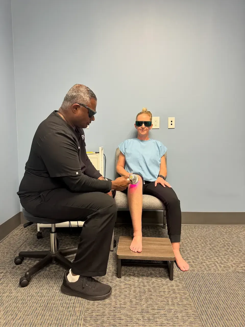 Dr. Rich Benjamin, D.C. performing LZR7 laser light therapy on a patient's knee at Gonstead Chiropractic Center in Fort Mill, SC.