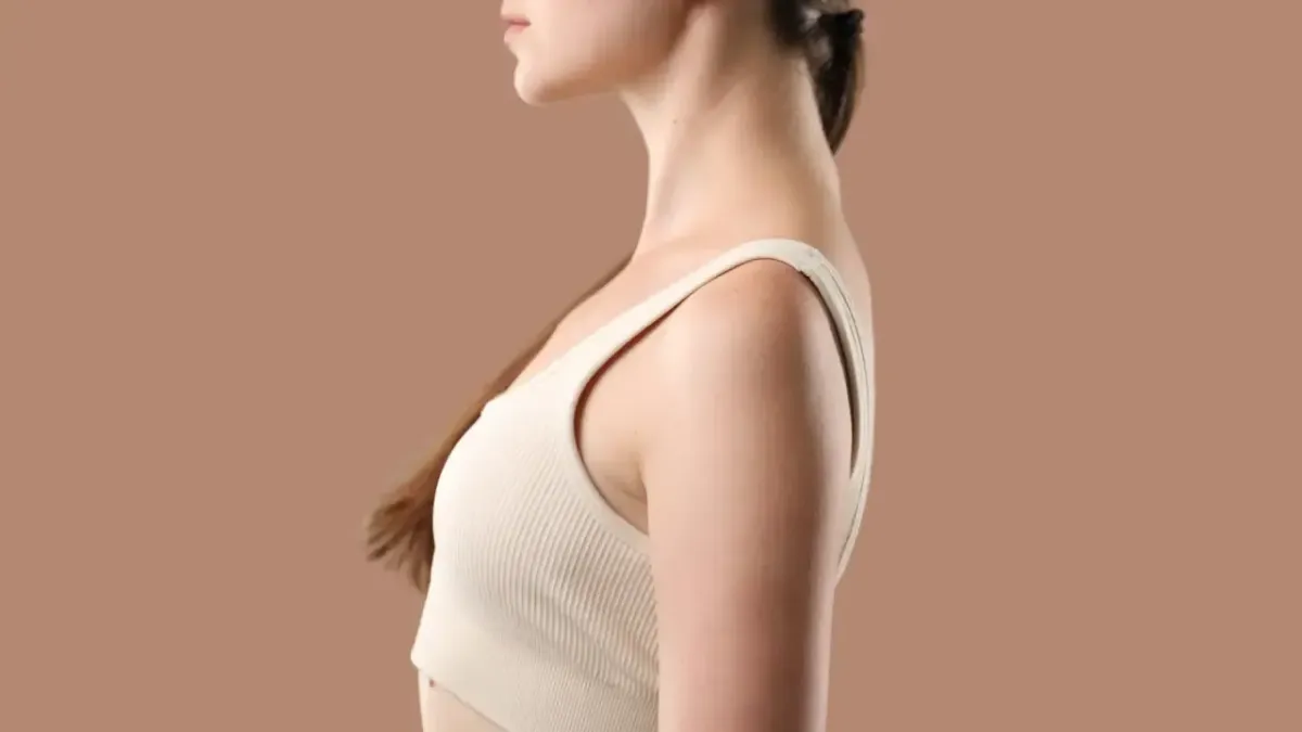 Profile view of a woman demonstrating ideal posture and neutral cervical spine alignment to prevent chronic lower back pain in Fort Mill, SC.