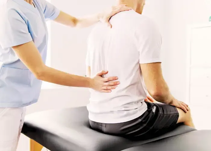 A chiropractor performing targeted manual therapy to release painful back muscle knots and provide myofascial pain relief in Fort Mill SC.