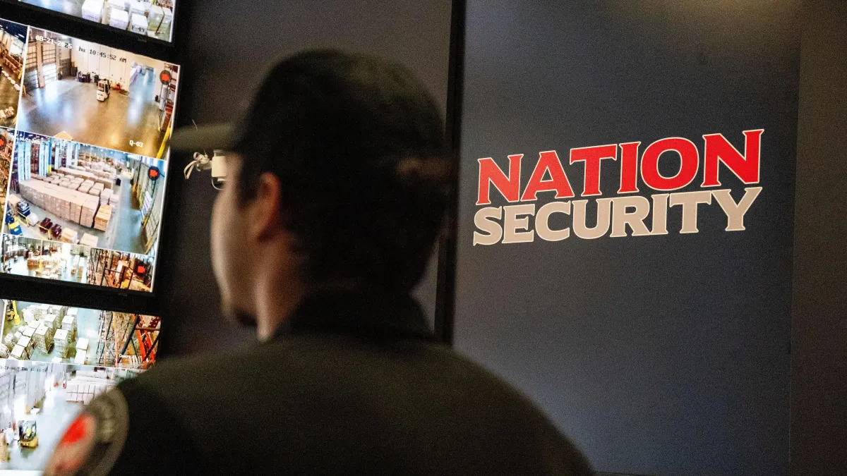 a bunch of cameras on a pole outside of a building