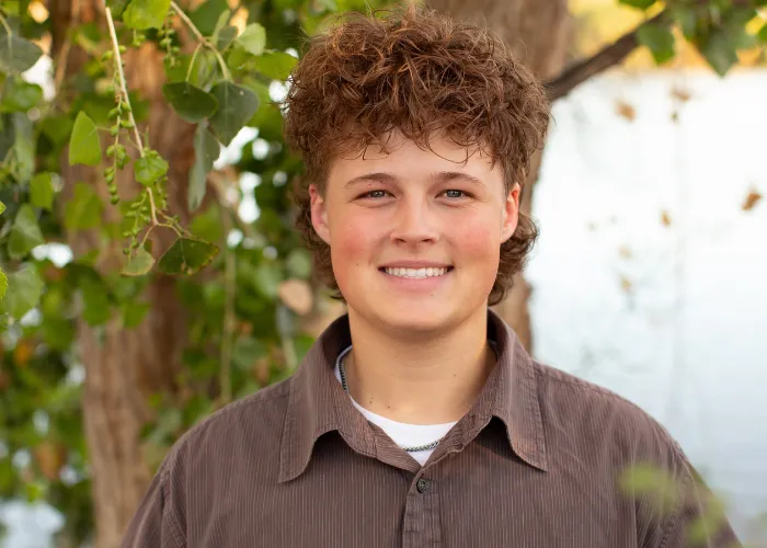 High school senior boy at the Riparian Preserve in Gilbert, AZ during a golden hour portrait session by Andria May Photography.