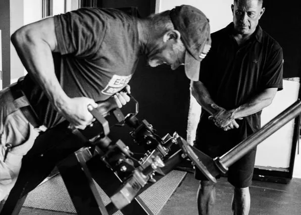 a young man working out with a barbell