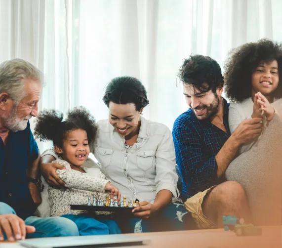 candid photo of a family in a casual bonding session discussing and a child playing chess