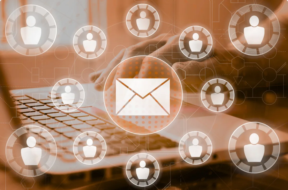 close up shot of a hand and a laptop with email and profile icons overlaid on top