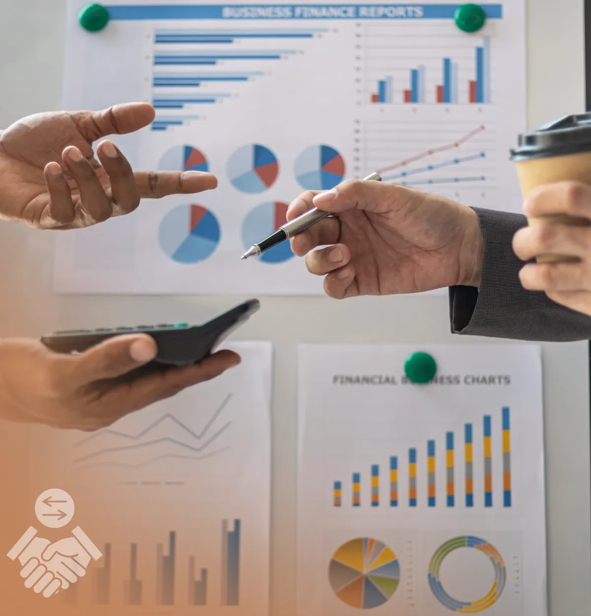 close up shot of the hands of two people holding a calculator and a pen discussing about numbers and charts