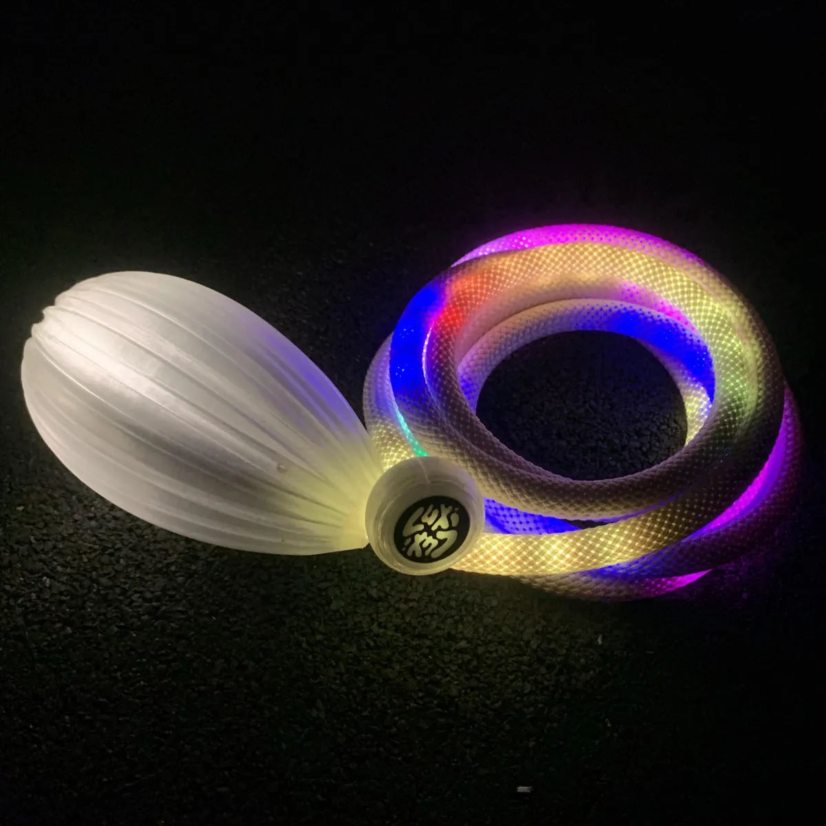 Bright meteor poi with glowing tails creating vibrant cyan and magenta light trails.